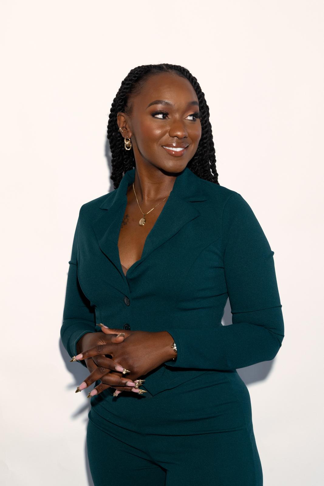 Businesswoman in a dark green suit photographed for a brand campaign