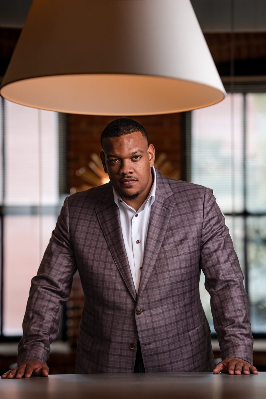 Attorney standing at a table in front of a bright window