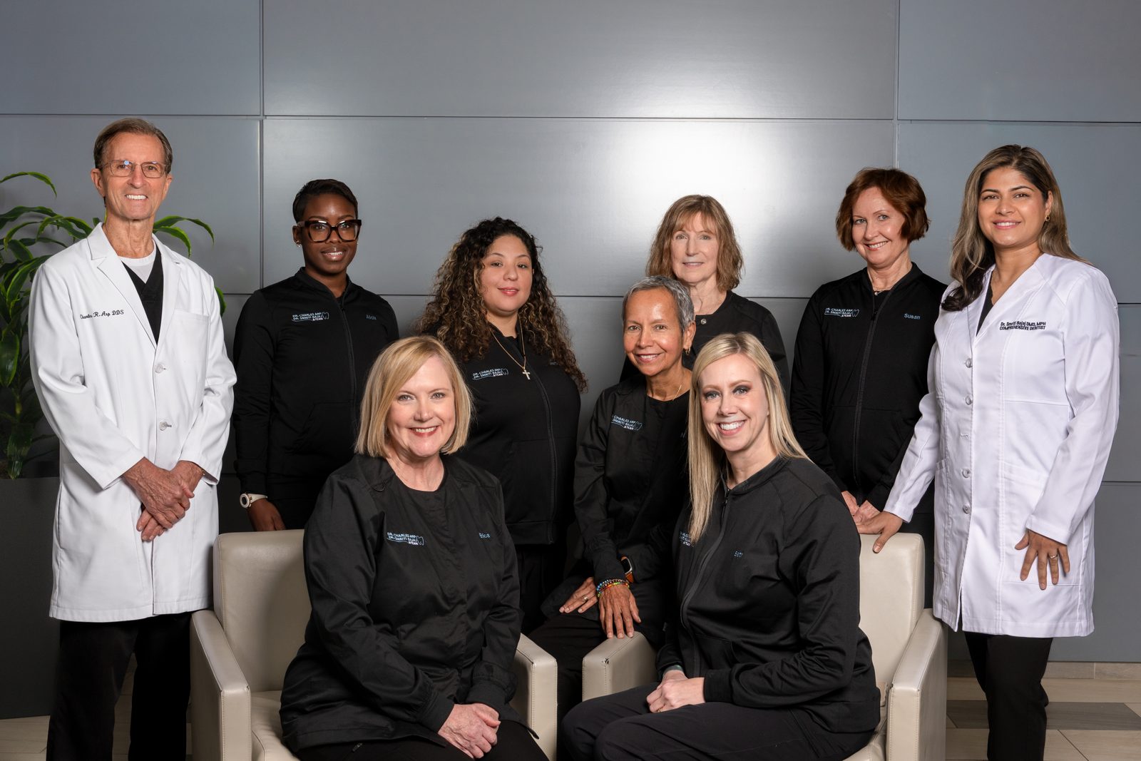 Dental practice team photographed together in a modern office