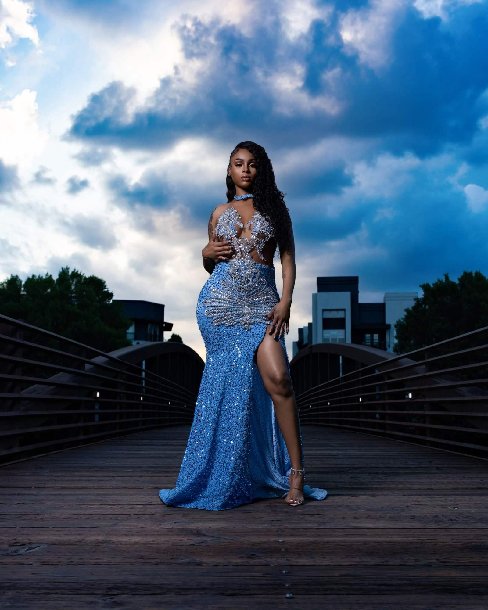 Fashion portrait in a blue gown under a dramatic Atlanta sky